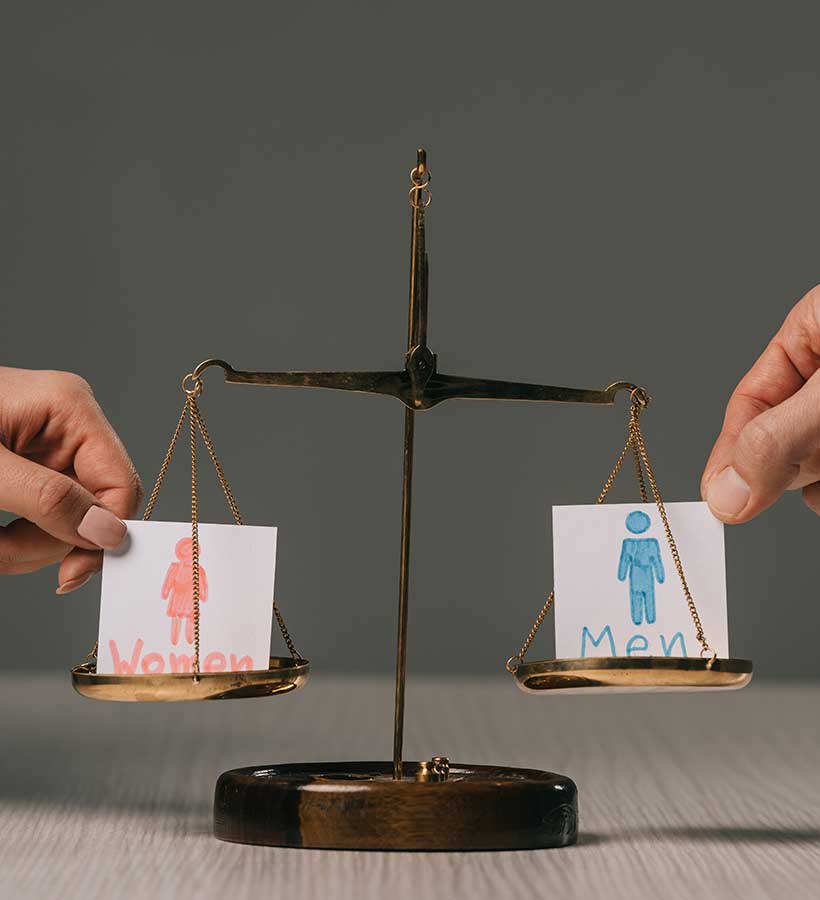 Una balanza entre dibujos de mujer y hombre